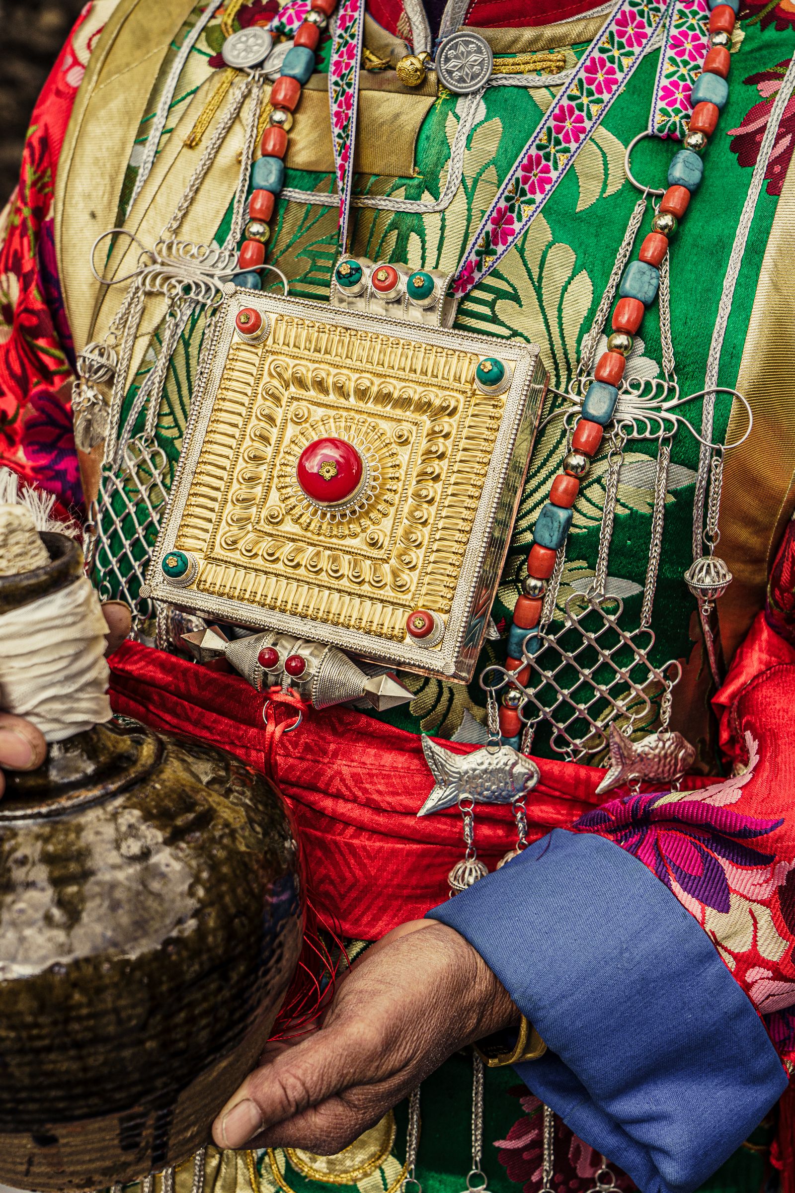 Fine embroidery, metalwork and layered textiles on a Tibetan robe