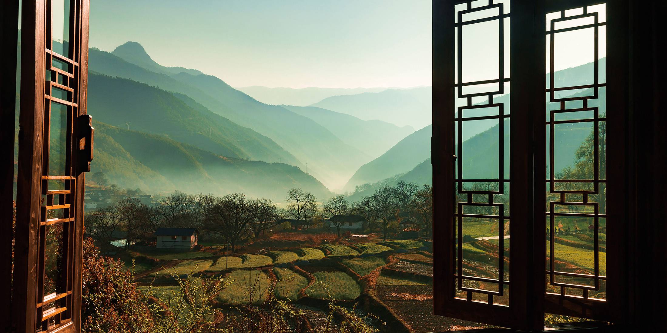 Tacheng rice terraces framed by the timber window of Songtsam Lodge